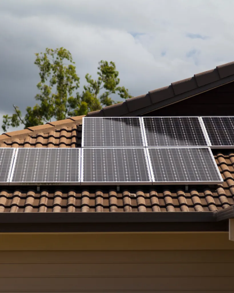 Solar panels fitted to the tiled roof of a house