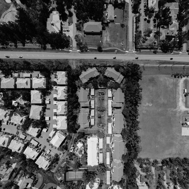 Aerial view of a residential apartment complex and surrounding streets