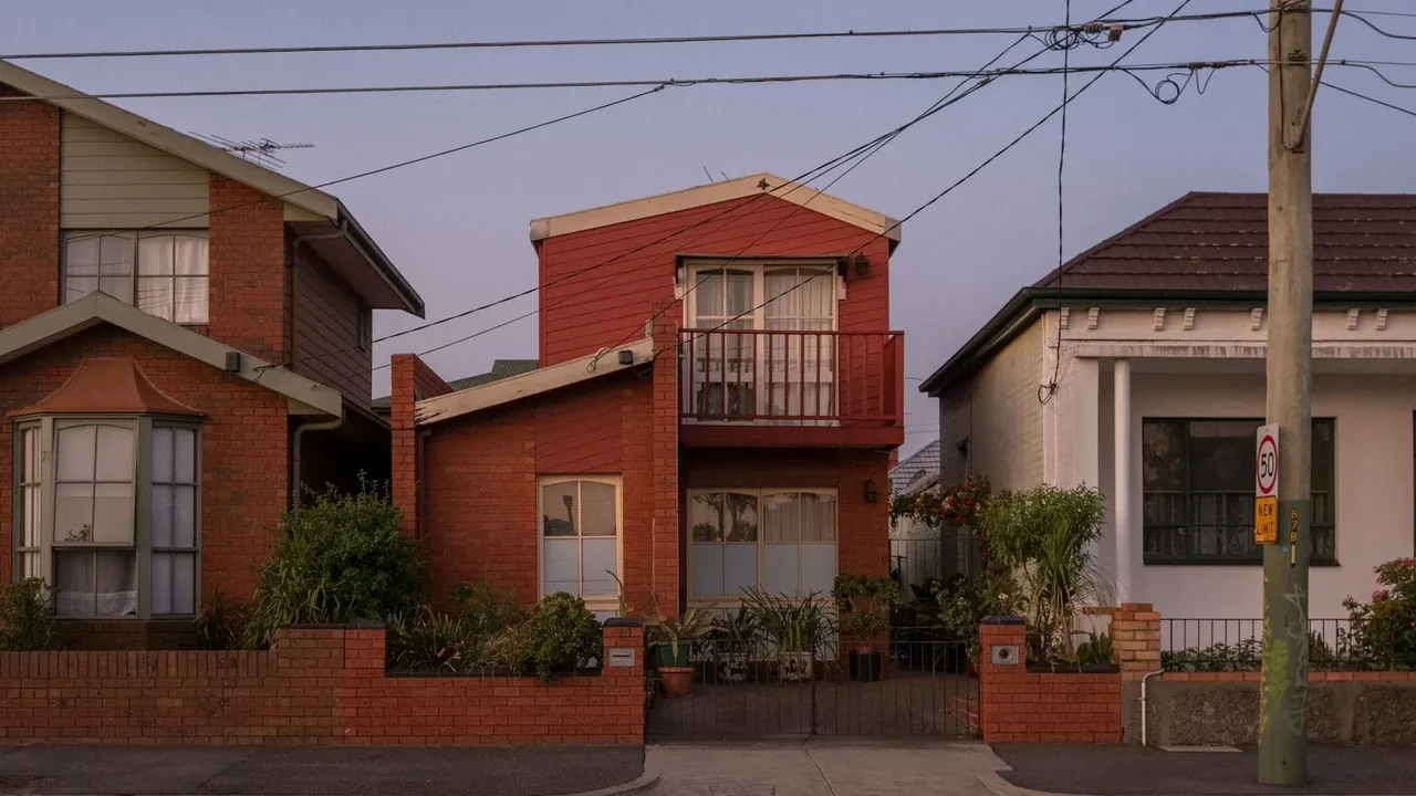 Red-brick houses beside a white rendered home on an inner-city Australian street Red-brick houses beside a white rendered home on an inner-city Australian street