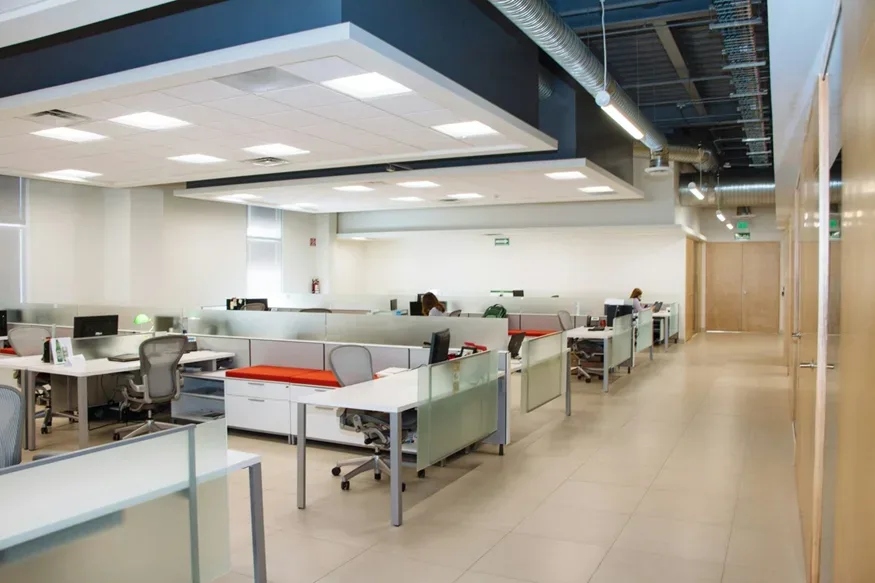 Open plan office with workstations, ceiling lights and exposed ductwork Open plan office with workstations, ceiling lights and exposed ductwork