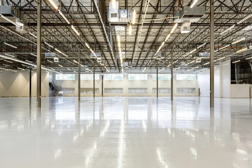 Empty warehouse with overhead air conditioning units and light fittings Empty warehouse with overhead air conditioning units and light fittings