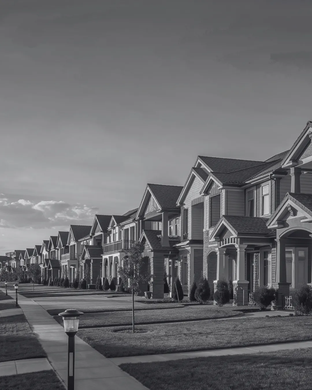 A row of near-identical two-storey suburban houses along a quiet street