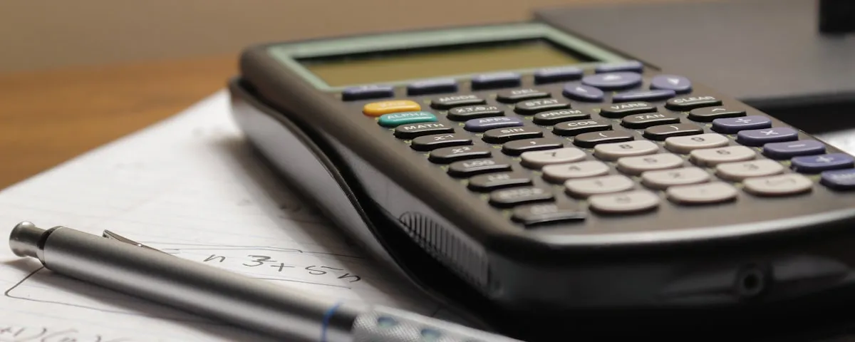 Calculator and pen on financial paperwork