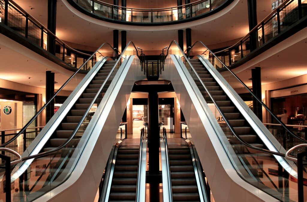 Commercial shopping centre interior with escalators, representing a commercial investment property eligible for a tax depreciation schedule