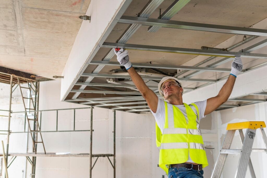 Builder installing ceiling framing during construction, representing plant and equipment assets claimable under Division 40 tax depreciation.