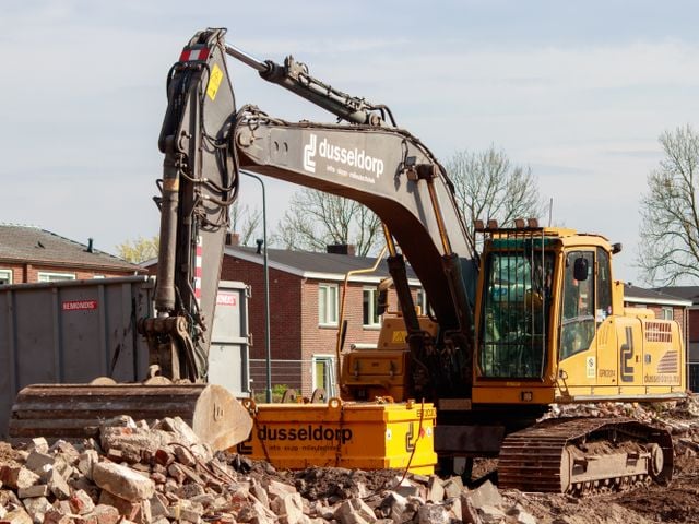 Renovating an investment property? The deductions you could miss out on (scrapping explained) » investment property renovation Demolition excavator clearing brick rubble in front of residential houses