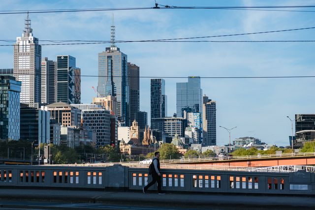 SMSF Property Valuations: How Often Does Your Fund Actually Need One? » smsf property valuations A pedestrian walking along a bridge with Melbourne's city towers in the background