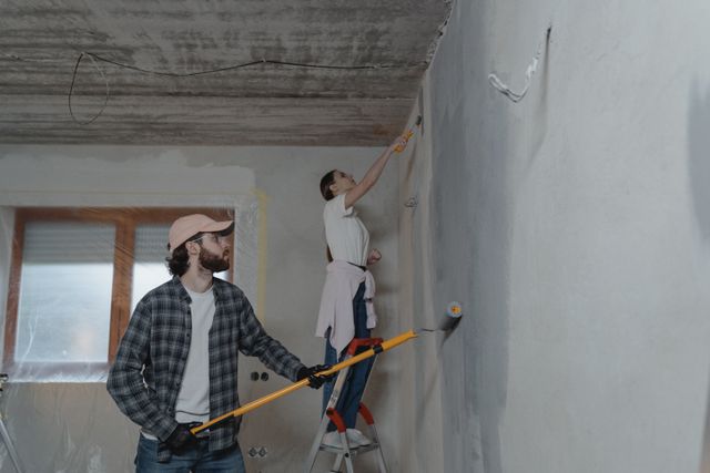 Renovating an investment property? The deductions you could miss out on (scrapping explained) » investment property renovation Two people renovating a room, one painting a wall with a roller and the other on a ladder
