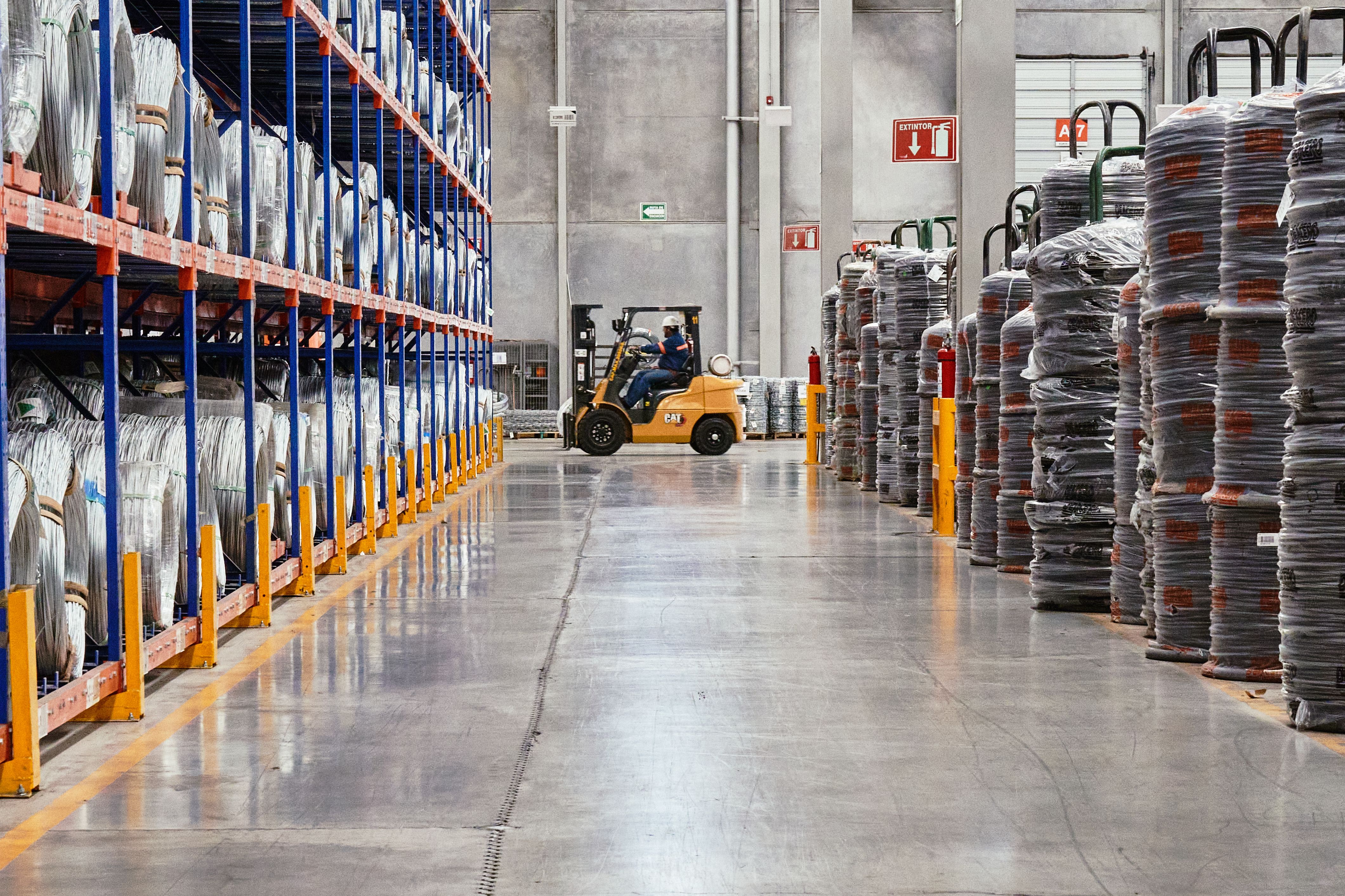 Commercial warehouse with pallet racking and forklift, representing an income-producing commercial property eligible for tax depreciation.
