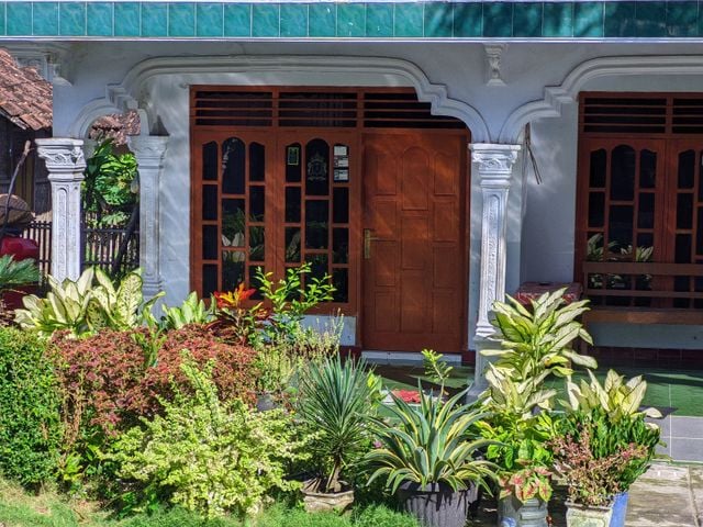 Exterior of an established second-hand property with a timber entry door" Placement: hero image, top of post, sets the "second-hand or older property