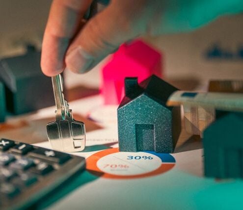 House keys, a calculator and miniature model houses with a depreciation percentage split