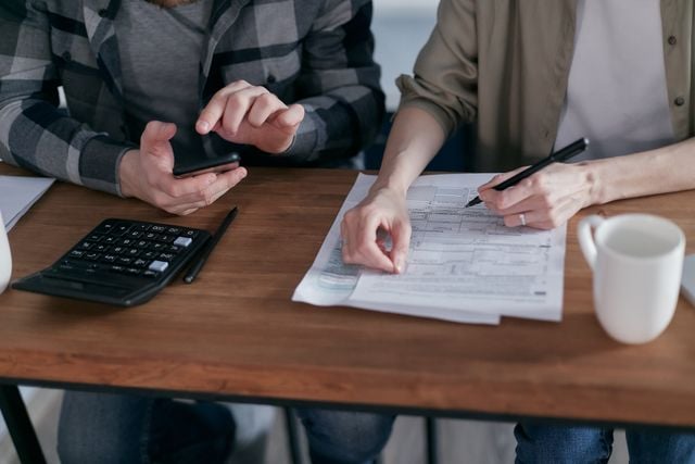 How your depreciation estimate is calculated: diminishing value and low-value pooling explained » diminishing value depreciation Two people reviewing paperwork and using a calculator at a table